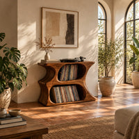 Hourglass record player stand with two stacked oval openings and a flat top in a bright living room with arched windows and plants