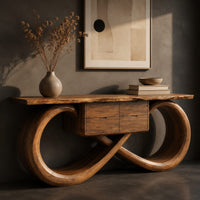 Corner detail of console table with an infinity loop base and small center box beside wood, brass and linen samples