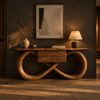 Console table with an infinity loop base and small center box in a dark entryway at golden hour