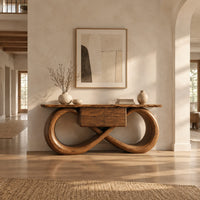 Console table with an infinity loop base and small center box in a bright open plan entryway