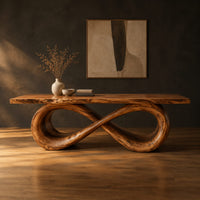 Rectangular dining table with a live edge top on a looped infinity base in a dark studio against a charcoal plaster wall