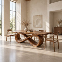 Rectangular dining table with a live edge top on a looped infinity base in a bright open plan dining room