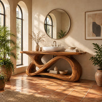 Bathroom vanity with a looping figure eight base and open shelf in a bright bathroom with arched windows and plants