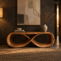Low bench with a flat top and a hollow figure eight loop base in a dark entryway at golden hour