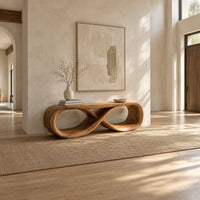 Low bench with a flat top and a hollow figure eight loop base in a bright open plan entryway