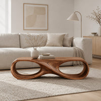 Coffee table shaped as an infinity loop with two oval openings in a Scandinavian living room with white walls