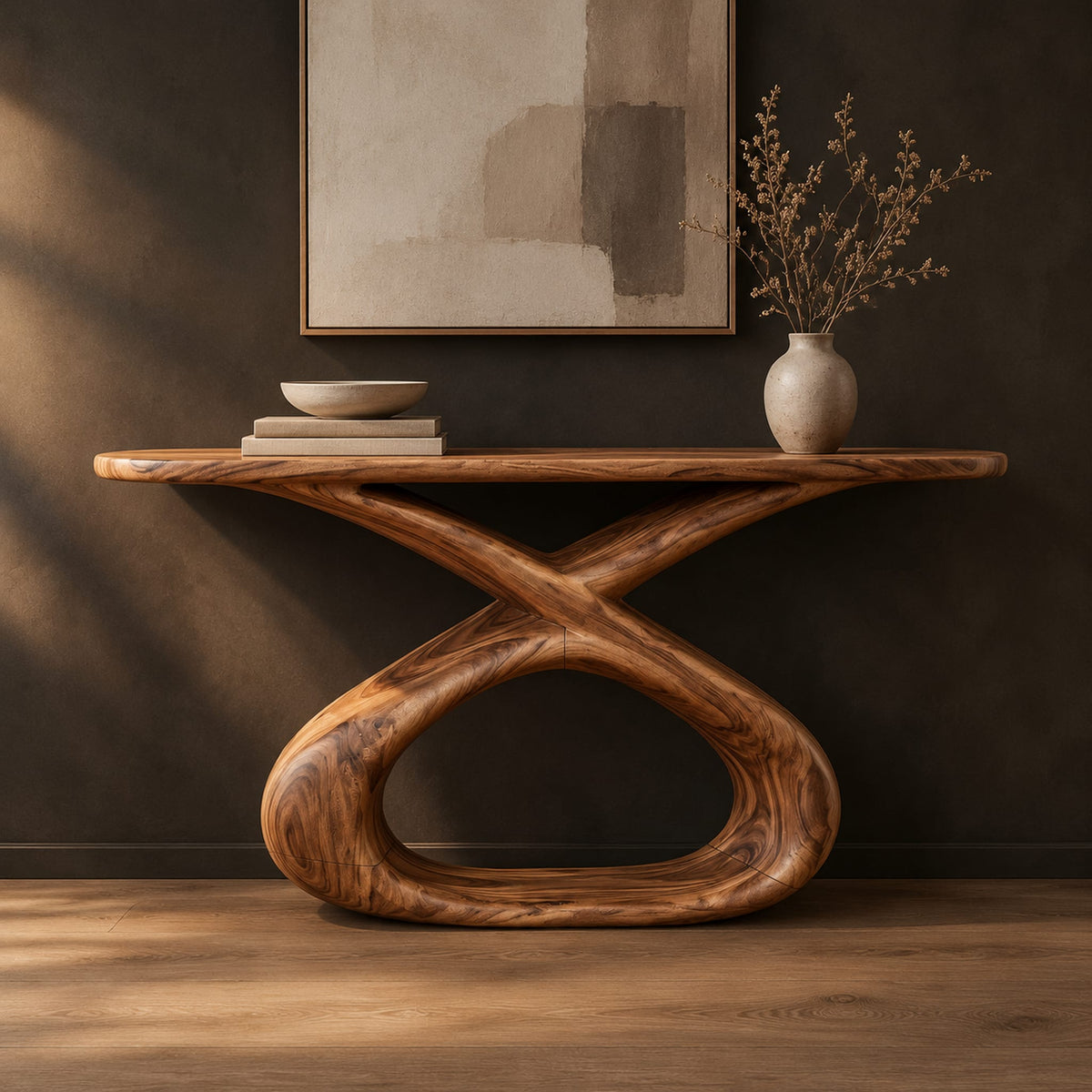 Console table with a long slab top on a twisted ribbon loop base in a dark studio against a charcoal plaster wall