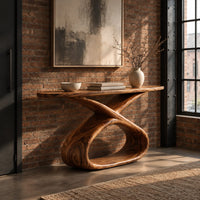Console table with a long slab top on a twisted ribbon loop base in an industrial loft entryway with exposed brick