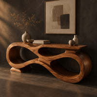 Corner detail of console table shaped as an infinity loop with open ribbon spaces beside wood, brass and linen samples