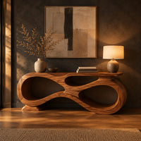 Console table shaped as an infinity loop with open ribbon spaces in a dark entryway at golden hour