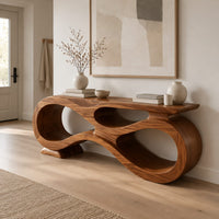 Console table shaped as an infinity loop with open ribbon spaces in a Scandinavian entryway with white walls