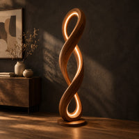 Twisted infinity loop floor lamp with a glowing inner edge, three-quarter view showing the grain