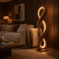 Twisted infinity loop floor lamp with a glowing inner edge in an evening living room with walnut wall paneling