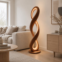 Twisted infinity loop floor lamp with a glowing inner edge in a Scandinavian living room with white walls