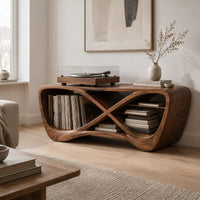 Infinity shaped record console with open bays and a smooth sculpted body in a Scandinavian living room with white walls