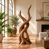 Interlaced branch sculpture with flame shaped tips and an open hollow near the base in a bright living room with arched windows and plants
