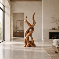 Interlaced branch sculpture with flame shaped tips and an open hollow near the base in a bright open plan living room