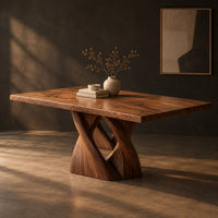 Rectangular dining table on a single pedestal of interlocking twisted ribbons, three-quarter view showing the grain