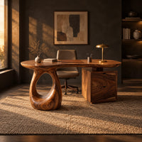Kidney shaped desk with a loop pedestal and a two drawer cabinet in a dark home office at golden hour