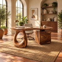 Kidney shaped desk with a loop pedestal and a two drawer cabinet in a bright home office with arched windows and plants