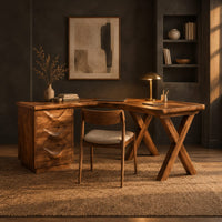 L shaped desk with a three drawer pedestal and crossed x legs in a dark home office at golden hour