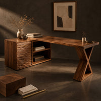 Corner detail of l shaped wood desk with ripple carved side unit and x shaped leg beside wood, brass and linen samples