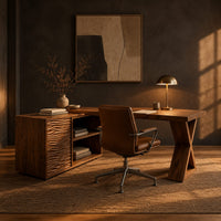 L shaped wood desk with ripple carved side unit and x shaped leg in a dark home office at golden hour