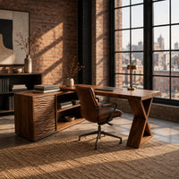 L shaped wood desk with ripple carved side unit and x shaped leg in an industrial loft home office with exposed brick