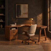 L shaped desk with a three drawer pedestal, open cubby and trestle leg in a dark home office at golden hour