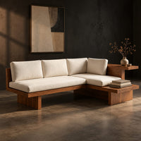 L shaped sofa with cream cushions on a low wood platform base, three-quarter view showing the grain