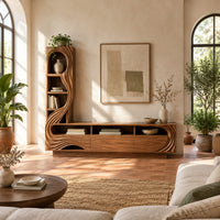 Tv stand with a tall arched shelf tower and flowing carved lines in a bright living room with arched windows and plants