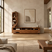 Tv stand with a tall arched shelf tower and flowing carved lines in a bright open plan living room