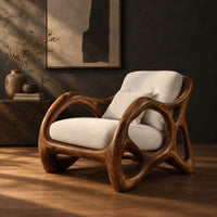 Lounge chair with large loop openings in the arms and sculpted legs, three-quarter view showing the grain