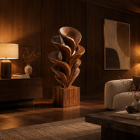 Wood sculpture of layered swirling petals rising from a square block base in an evening living room with walnut wall paneling
