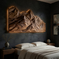 Layered ridge carved mountain wall art on a dark charcoal plaster wall