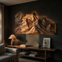 Layered ridge carved mountain wall art above a low console in an evening living room