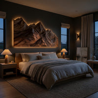 Layered ridge carved mountain wall art above a bed in a dusk lit bedroom