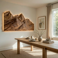 Layered ridge carved mountain wall art beside a dining table in natural light