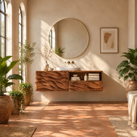 Floating vanity with layered carved ridges and an open shelf on the right in a bright bathroom with arched windows and plants