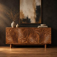 Sideboard with four layered swirl carved panels on sturdy legs in a dark studio against a charcoal plaster wall