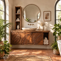 Leaf carved bathroom vanity cabinet with three panels and an open cubby in a bright bathroom with arched windows and plants