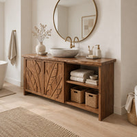 Bathroom vanity with leaf carved doors and an open shelf bay beside them in a Scandinavian bathroom with white walls