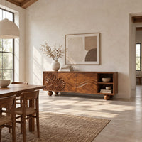 Sideboard with leaf carved doors, ball feet and an open shelf bay in a bright open plan dining room