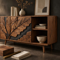 Corner detail of low sideboard with carved leaf panels, an open shelf section and tapered legs beside wood, brass and linen samples