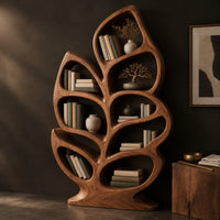 Corner detail of leaf shaped bookshelf with branching veins forming oval shelves beside wood, brass and linen samples