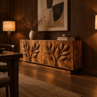 Sideboard with two carved leafy branches across four doors on a plinth in an evening dining room with walnut wall paneling