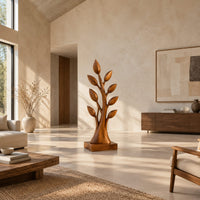Tree shaped wood sculpture with leaf tips and a flared trunk in a bright open plan living room