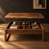 Wooden lift top coffee table with divided compartments and square frame legs in a dark studio against a charcoal plaster wall