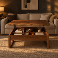 Wooden lift top coffee table with divided compartments and square frame legs in a dark living room at golden hour