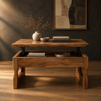 Lift top coffee table with open compartment and bean shaped cutout legs in a dark studio against a charcoal plaster wall